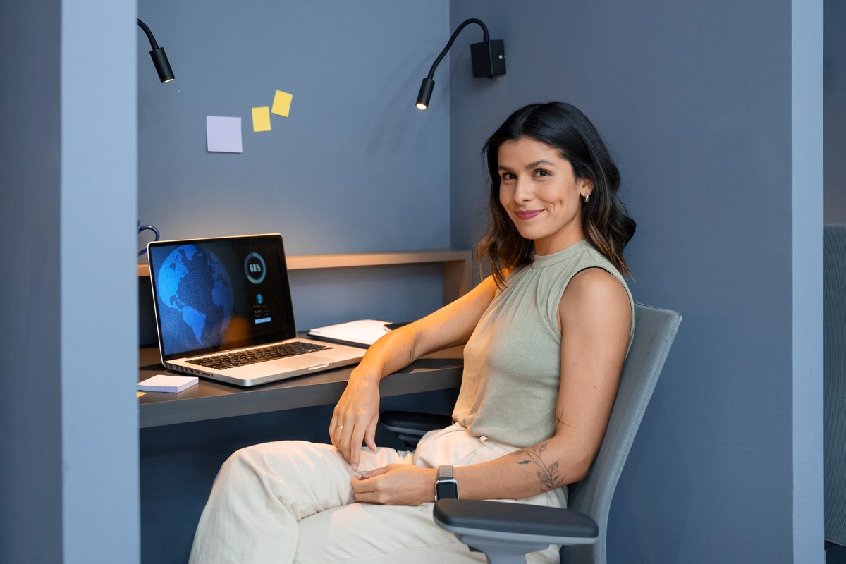 A team member working at a desk with a laptop
